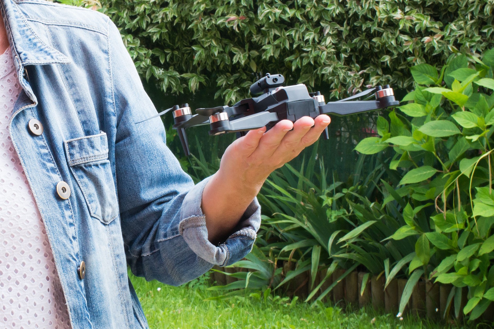Close up of caucasian woman hand holding a small drone outdoors